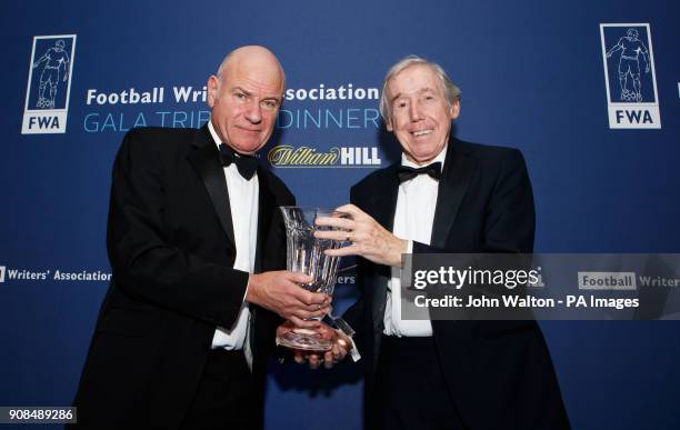 Chairman of the FWA Patrick Barclay hands the trophy to Gordon Banks on behalf of Pele during the Football Writers Association Tribute Night at The...
