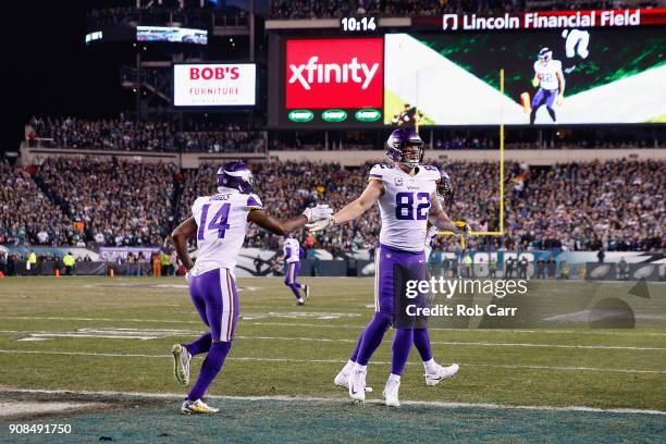 Kyle Rudolph is congratulated by his teammate Stefon Diggs of the Minnesota Vikings after scoring a first quarter touchdown against the Philadelphia...