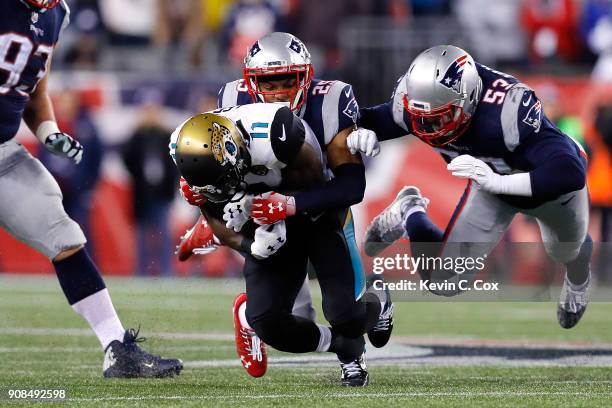 Marqise Lee of the Jacksonville Jaguars is tackled by Eric Rowe of the New England Patriots and Kyle Van Noy in the second half during the AFC...