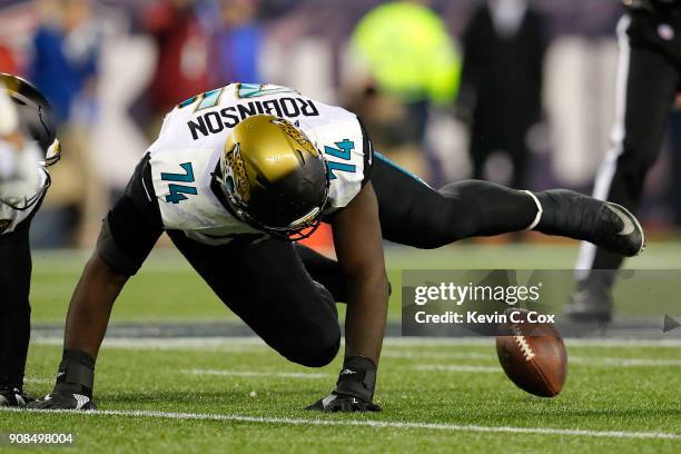 Cam Robinson of the Jacksonville Jaguars attempts to recover a fumble in the second half against the New England Patriots during the AFC Championship...