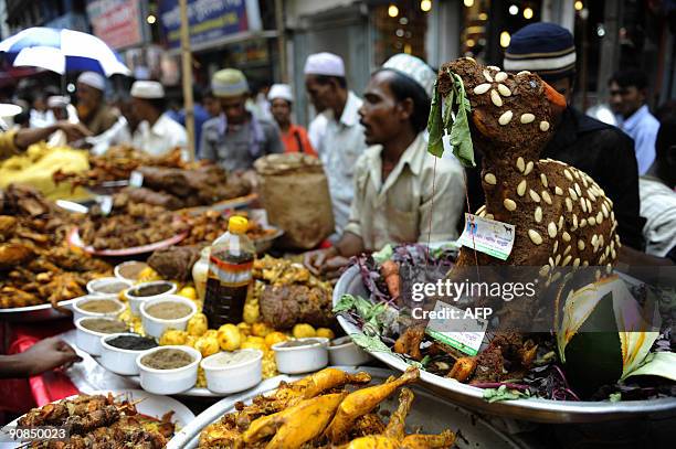 Bangladeshi street vendors prepare iftar, food for breaking the daytime fast, at a traditional iftar bazaar in the old part of Dhaka on August 23 the...
