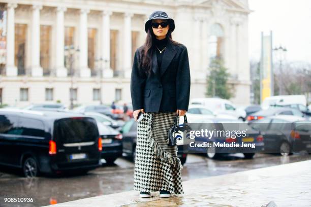 Christina Paik attends the Y3 show and wears a Supreme bucket hat on January 21, 2018 in Paris, France.