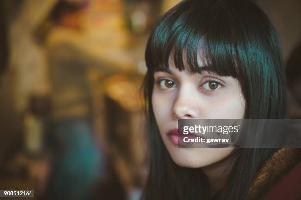 serene young woman looking at camera. - black hair stock pictures, royalty-free photos & images