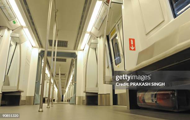 Fire extinguisher is seen under a passenger seat in one of Delhi Metro's new broad gauge trains manufactured by Bombardier during a preview in New...