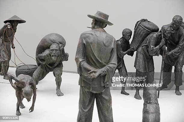 Sculptures of the exhibition "Art for millions - 100 sculptures from the Mao era" are prepared at the Schirm gallery in the central German city of...