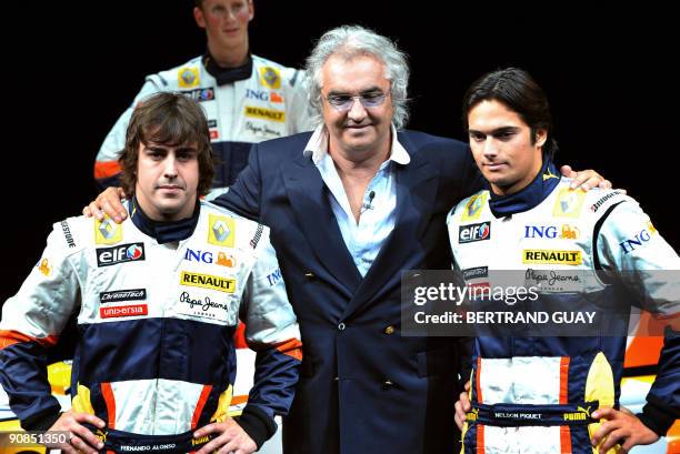 Photo taken on January 31, 2008 of Renault drivers Spain's Fernando Alonso and Brazilian Nelson Piquet Jr with team boss Flavio Briatore posing...