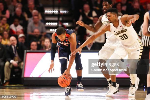 Virginia Cavaliers guard Devon Hall tries to keep control with Wake Forest Demon Deacons forward Terrence Thompson giving chase during the ACC...