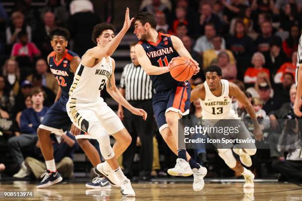 Virginia Cavaliers guard Ty Jerome tries for a pass guarded by Wake Forest Demon Deacons forward Terrence Thompson during the ACC matchup on January...