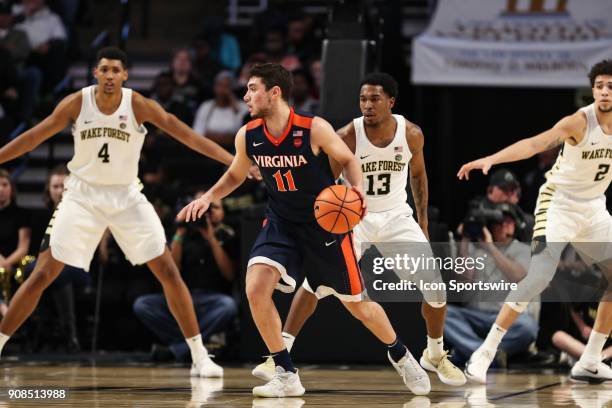 Virginia Cavaliers guard Ty Jerome works the ball covered by Wake Forest Demon Deacons guard Bryant Crawford during the ACC matchup on January 21,...