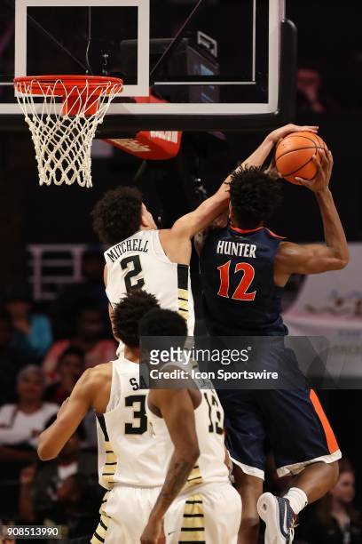 Wake Forest Demon Deacons forward Donovan Mitchell blocks a shot by Virginia Cavaliers guard De'Andre Hunter during the ACC matchup on January 21,...