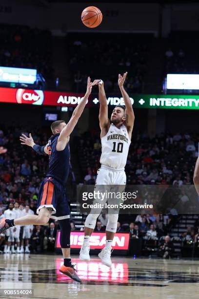 Wake Forest Demon Deacons guard Mitchell Wilbekin shoots a three over Virginia Cavaliers guard Kyle Guy during the ACC matchup on January 21, 2018...