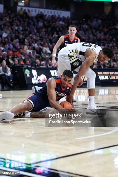 Virginia Cavaliers forward Isaiah Wilkins holds onto the ball despite the attempts by Wake Forest Demon Deacons forward Terrence Thompson to hold it...