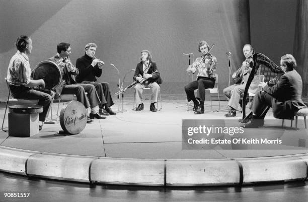 Irish folk group The Chieftains, performing on a TV show, 1976. Left to right: Peadar Mercier, Michael Tubridy, Sean Potts, Paddy Moloney, Sean...