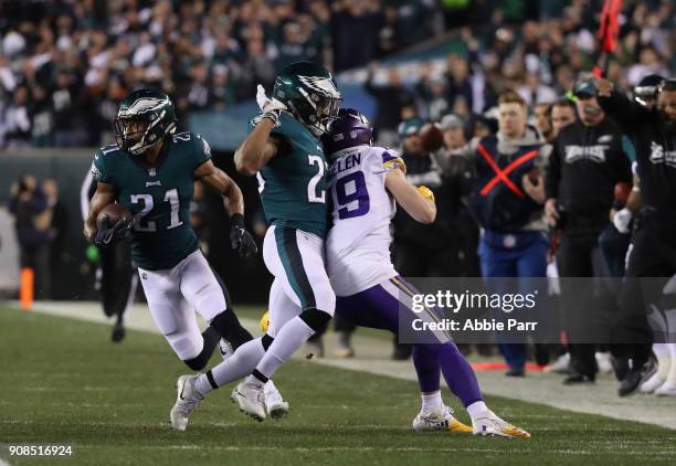 Adam Thielen of the Minnesota Vikings is blocked by Rodney McLeod as Patrick Robinson of the Philadelphia Eagles returns an interception for a...