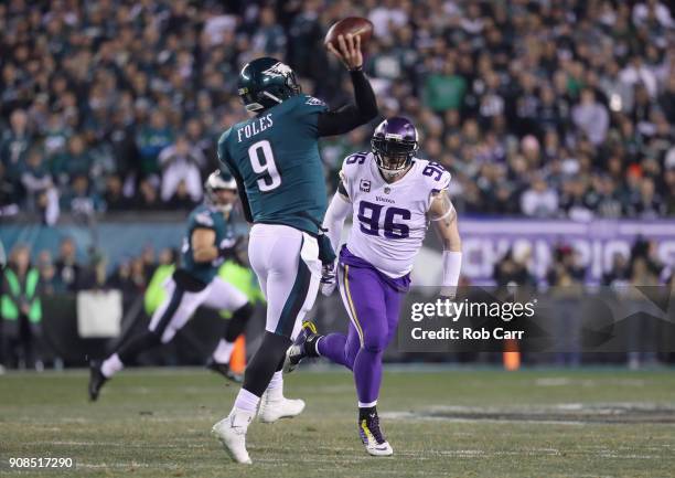 Nick Foles of the Philadelphia Eagles looks to pass during the first quarterunder pressure from Brian Robison of the Minnesota Vikings in the NFC...