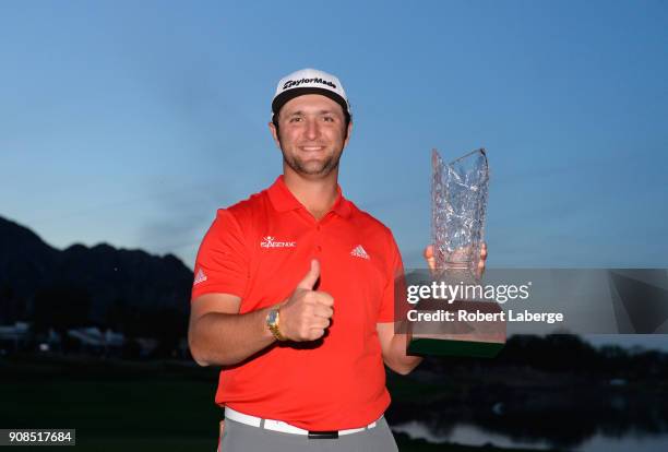 Jon Rahm of Spain poses with the trophy after putting in to win on the fourth hole of a sudden death playoff during the final round of the...