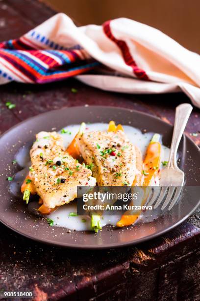 roasted white fish fillet with cream sauce and baby carrots on a plate, selective focus - peppercorn sauce stock pictures, royalty-free photos & images
