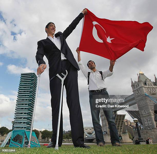 The worlds new tallest man Sultan Kosen 26, of Turkey poses with his brother Hasan Kosen in front of Tower Bridge to celebrate the launch of the 2010...