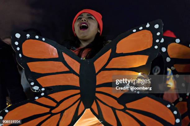 Demonstrator chants while wearing a butterfly cutout during a rally supporting the Deferred Action for Childhood Arrivals program , or the Dream Act,...