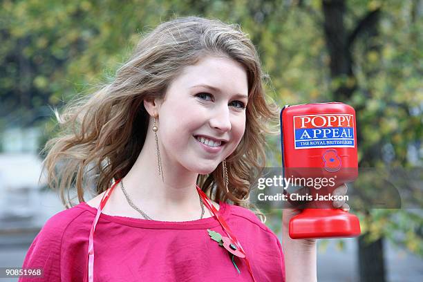 Singer Hayley Westenra poses with a Poppy Appeal collection box during a photocall for Poppy Appeal Recruitment on September 16, 2009 in London,...