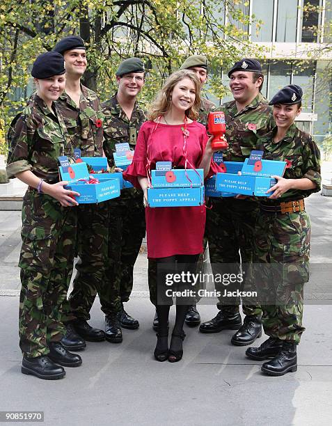 Singer Hayley Westenra poses with aarmy officer cadets during a photocall for Poppy Appeal Recruitment on September 16, 2009 in London, England. The...