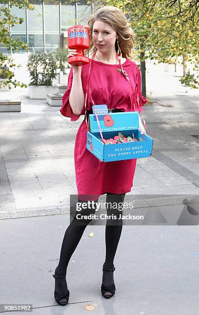 Singer Hayley Westenra poses with a Poppy Appeal collection box during a photocall for Poppy Appeal Recruitment on September 16, 2009 in London,...