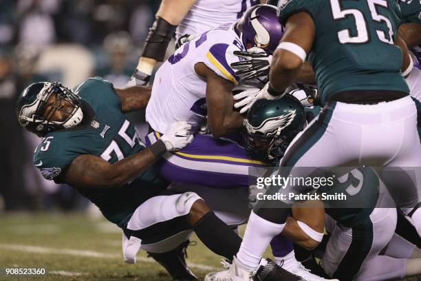 Latavius Murray of the Minnesota Vikings is tackled by Vinny Curry of the Philadelphia Eagles during the second quarter in the NFC Championship game...