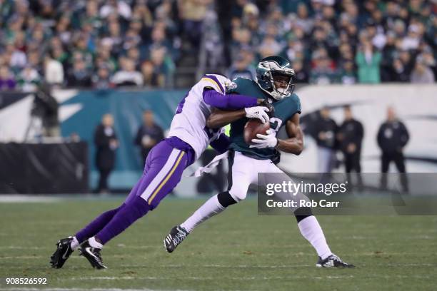 Nelson Agholor of the Philadelphia Eagles is tackled by Harrison Smith of the Minnesota Vikings during the first quarter in the NFC Championship game...