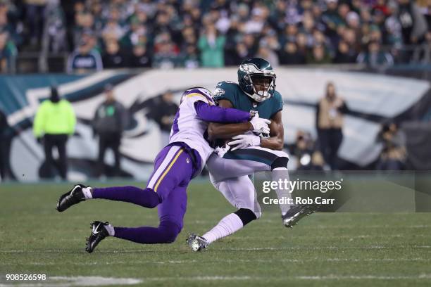 Nelson Agholor of the Philadelphia Eagles is tackled by Harrison Smith of the Minnesota Vikings during the first quarter in the NFC Championship game...