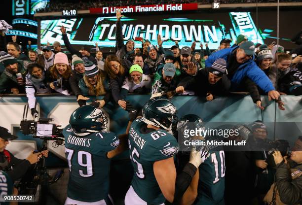 Brandon Brooks, Lane Johnson and Mack Hollins of the Philadelphia Eagles celebrate with the fans after a fourth quarter touchdown against the...