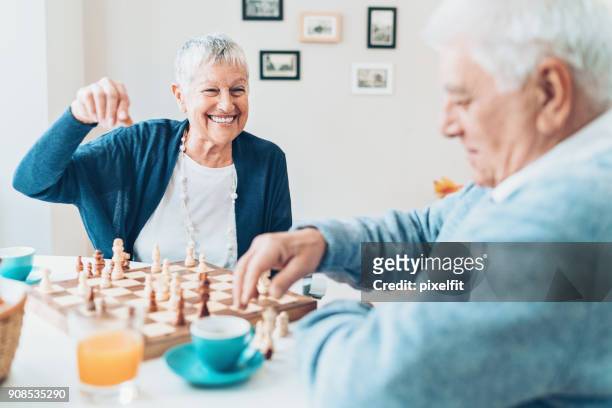 always having fun together - senior playing chess stock pictures, royalty-free photos & images