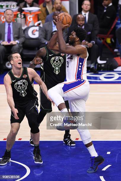 Joel Embiid of the Philadelphia 76ers drives to the basket against Marshall Plumlee of the Milwaukee Bucks during the first half of the game at Wells...