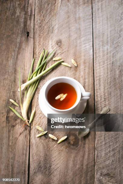 a cup of lemon grass tea on rustic wooden background. - erva cidreira imagens e fotografias de stock