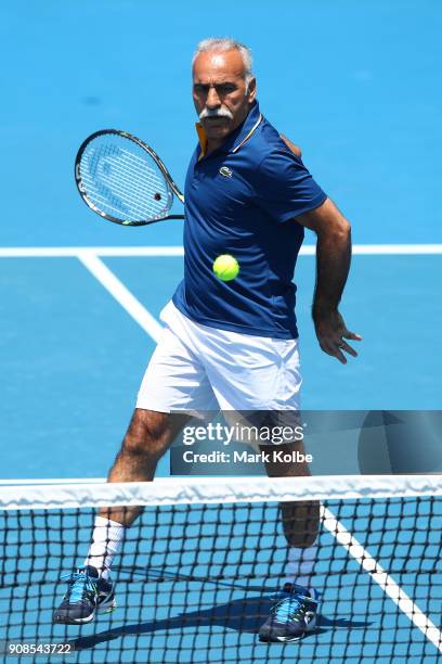 Mansour Bahrami of France plays a forehand in his legend's match with Fabrice Santoro of France against Pat Cash of Australia and Mark Woodforde of...