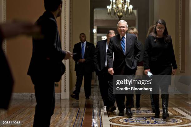 Senate Majority Leader Mitch McConnell, a Republican from Kentucky, second right, walks to the Senate Chamber at the U.S. Capitol in Washington,...