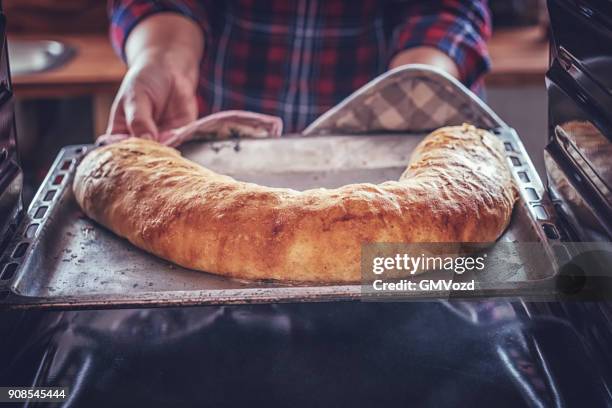 baking homemade apfelstrudel in the oven - strudel stock pictures, royalty-free photos & images