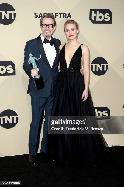 Actor Gary Oldman, winner of Outstanding Performance by a Male Actor in a Leading Role for 'Darkest Hour', and host Kristen Bell pose in the press...