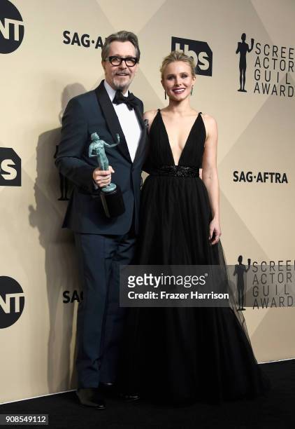 Actor Gary Oldman, winner of Outstanding Performance by a Male Actor in a Leading Role for 'Darkest Hour,' and host Kristen Bell pose in the press...