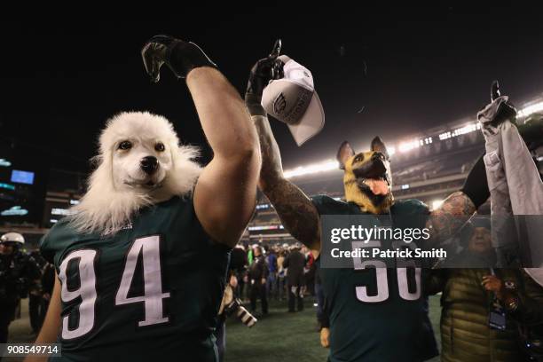 Beau Allen and Chris Long of the Philadelphia Eagles celebrates their teams win while wearing a dog masks over the Minnesota Vikings in the NFC...