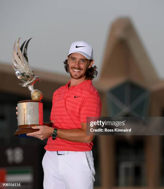 Tommy Fleetwood of England celebrates with the winners trophy after the final round of the Abu Dhabi HSBC Golf Championship at Abu Dhabi Golf Club on...