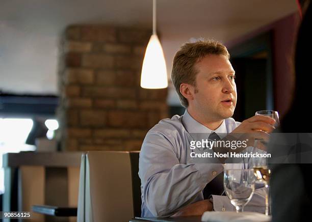 businessman dining with others - moving down to seated position stock pictures, royalty-free photos & images
