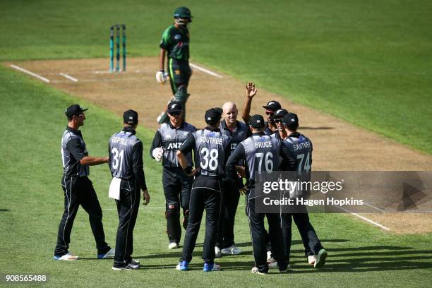 Seth Rance of New Zealand celebrates with teammates after taking the wicket of Hasan Ali of Pakistan during game one of the Twenty20 series between...