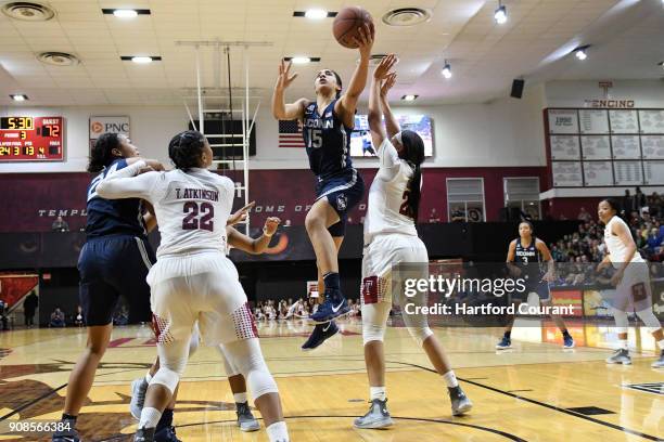 Connecticut Huskies forward Gabby Williams splits the defense of Temple Owls guard Tanaya Atkinson and Temple Owls forward Mia Davis during the...