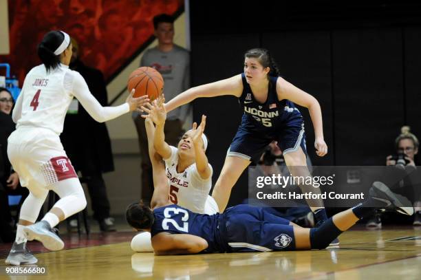 Temple Owls forward Mia Davis passes the ball to Temple Owls guard Mykia Jones after battling for a loose ball with Connecticut Huskies forward Azura...