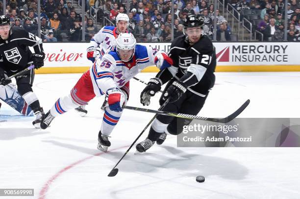 Nick Shore of the Los Angeles Kings battles for the puck against Nick Holden of the New York Rangers at STAPLES Center on January 21, 2018 in Los...