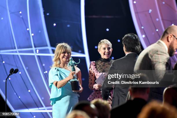 Actor Milo Ventimiglia walks onstage to accept Outstanding Performance by an Ensemble in a Drama Series for 'This Is Us' from actors Goldie Hawn and...