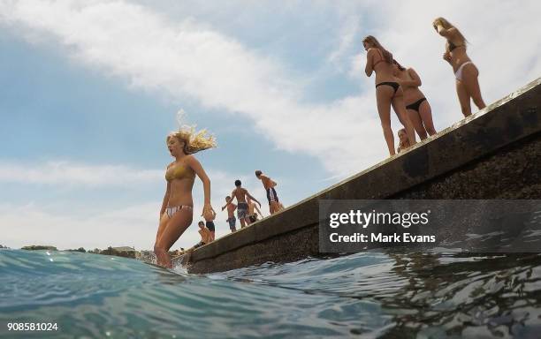 Girl jumps into the ocean at Clovelly on January 22, 2018 in Sydney, Australia. Sydney's CBD reached a top of 33 degrees Celcius today, while...