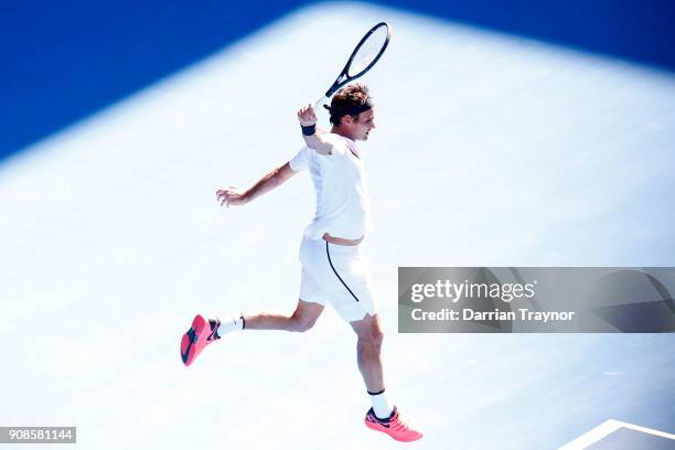 Roger Federer of Switzerland plays a backhand in his fourth round match against Marton Fucsovics of Hungary on day eight of the 2018 Australian Open...