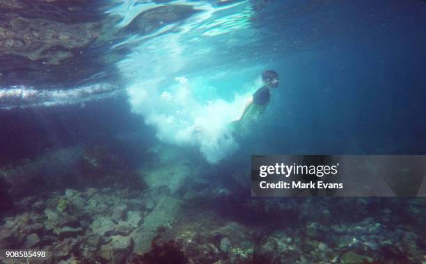 Boy dives into the ocean at Clovelly on January 22, 2018 in Sydney, Australia. Sydney's CBD reached a top of 33 degrees Celcius today, while...