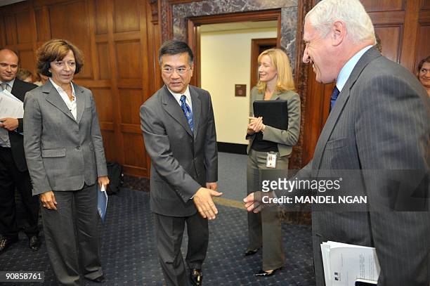 French Minister of State for Foreign Trade Anne-Marie Idrac watches as US Commerce Secretary Gary Locke shakes hands with French Ambassador to the US...